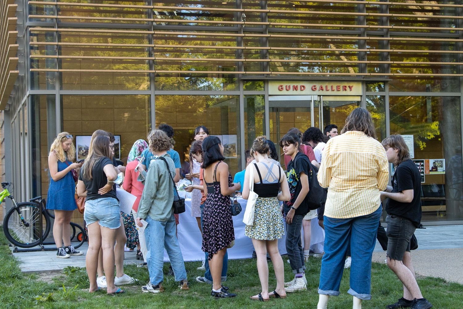 A crowd of students gathers outside the Gund Gallery for the button making table during Community Feast.