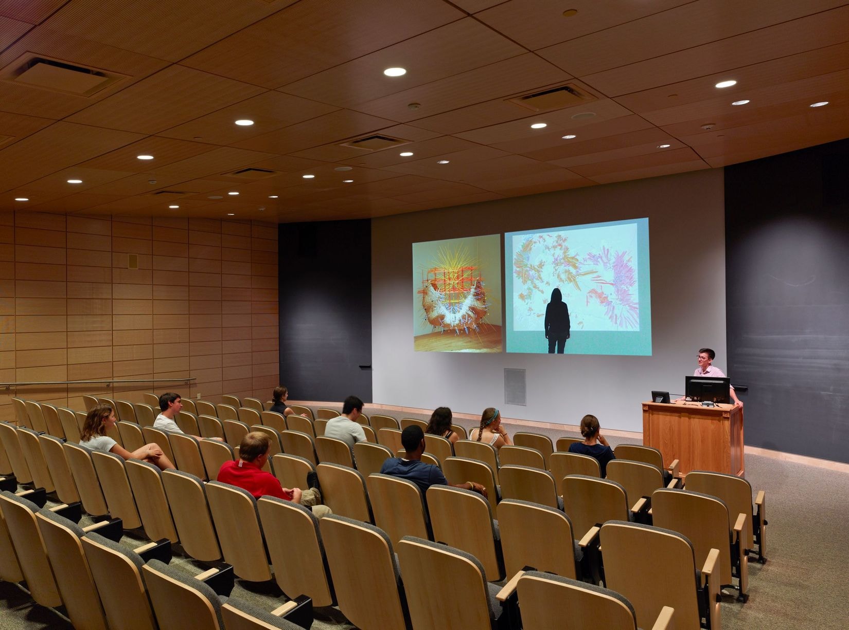 A view of the auditorium/theater with students and a speaker in The Gund Gallery.
