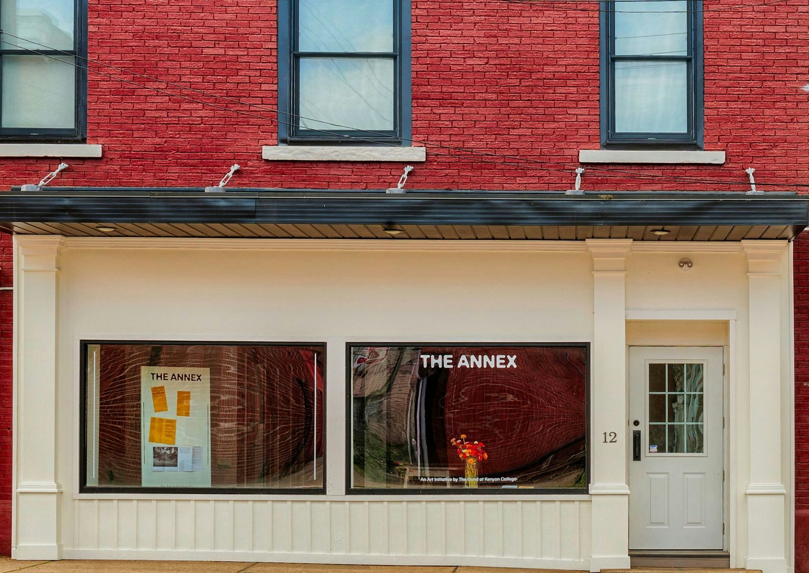 A frontal view of The Annex storefront in downtown Mount Vernon, OH. The building is brick red, but the storefront is painted eggshell. 