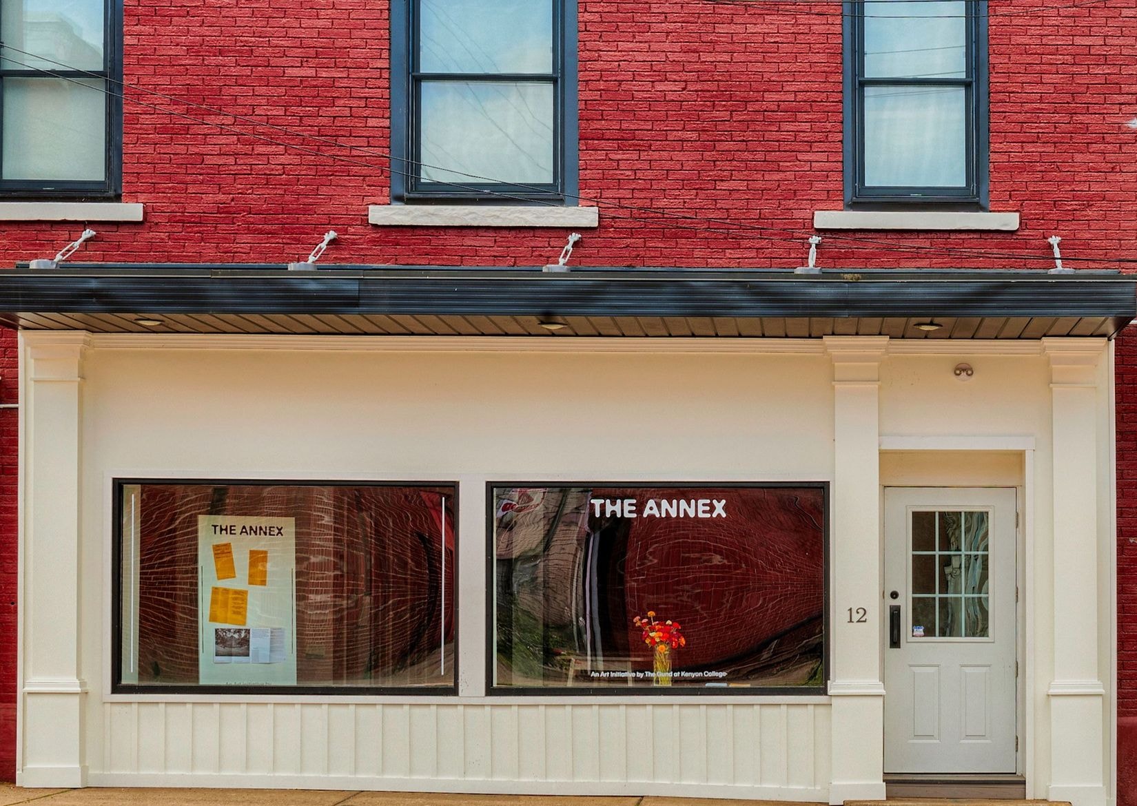 A frontal view of The Annex storefront in downtown Mount Vernon, OH. The building is brick red, but the storefront is painted eggshell.