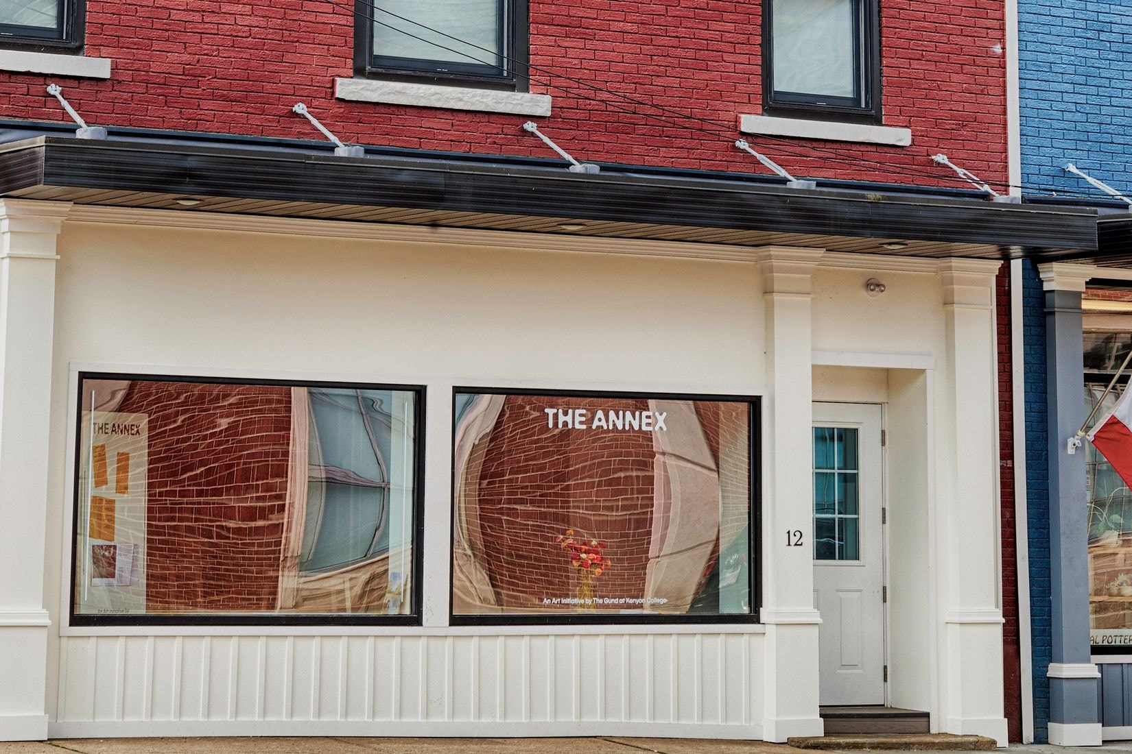 A frontal view of The Annex storefront in downtown Mount Vernon, OH. The building is brick red, but the storefront is painted eggshell.